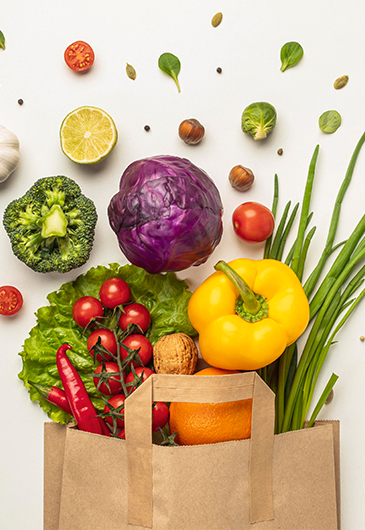 Top view of assortment of vegetables in paper bag